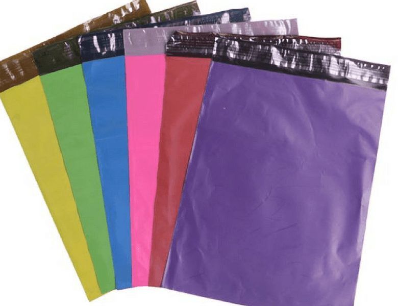 A fan of six rectangular plastic envelopes in yellow, green, blue, pink, red, and purple, each with a black adhesive strip at the top.