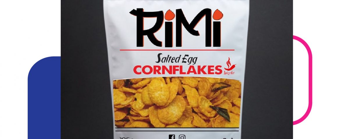 A white stand-up pouch bag containing salted egg cornflakes with the brand name Rimi printed on the front.