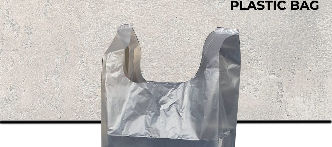 A clear, thin plastic singlet-style shopping bag standing upright against a textured grey background.