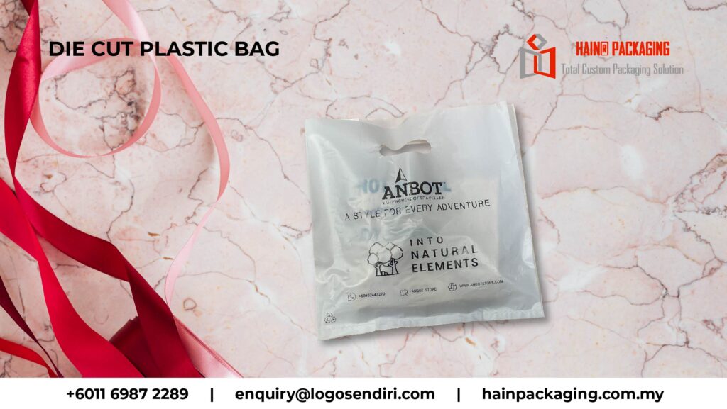 A white die-cut plastic bag with branding on a marble-patterned surface with red ribbons.