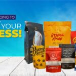 A collection of various food and pet product pouches arranged on a white wooden surface against a blue background.