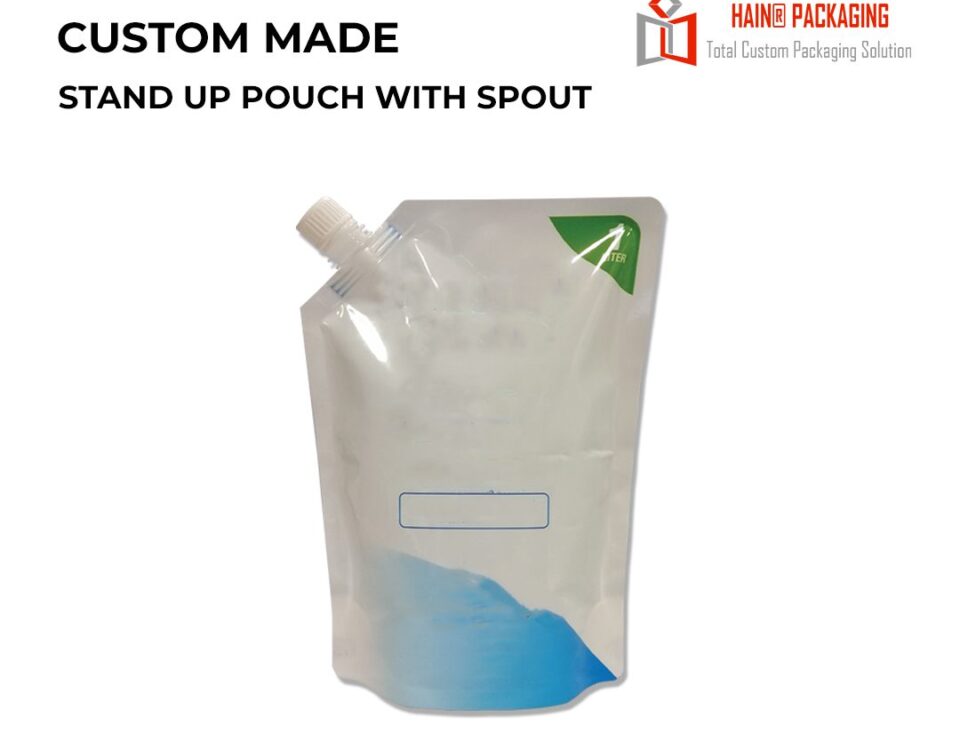 A clear stand-up pouch with a white plastic spout, featuring a blue graphic at the bottom and a green triangle in the top corner.
