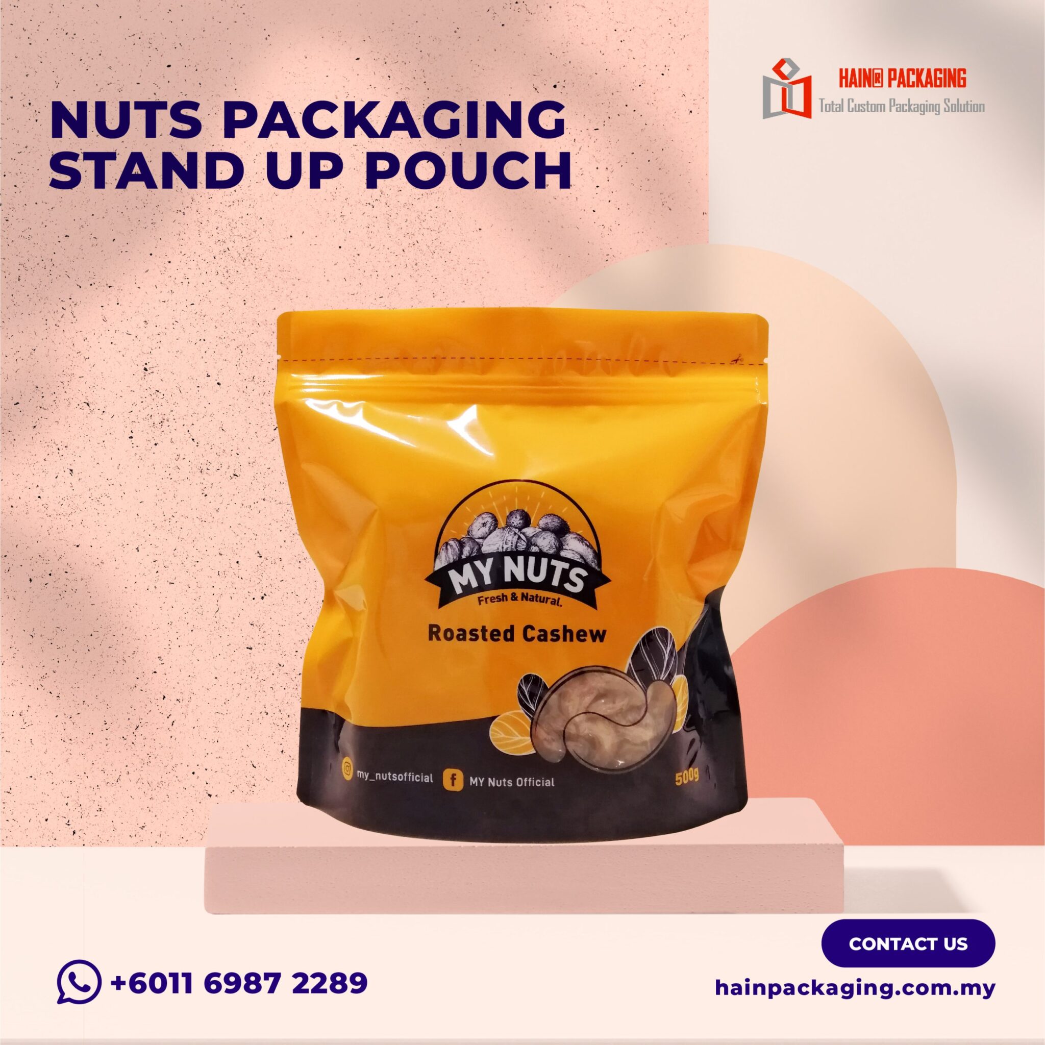 A yellow and black stand-up pouch labeled My Nuts Roasted Cashew sitting on a platform against a pink background.